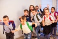 Happy school kids running in elementary school hallway, front view Royalty Free Stock Photo