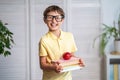 Happy schoolboy with books and an Apple in his hands. Back to school Royalty Free Stock Photo