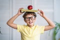 Happy schoolboy with books and an Apple in his hands. Back to school Royalty Free Stock Photo