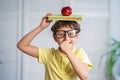 Happy schoolboy with books and an Apple in his hands. Back to school Royalty Free Stock Photo