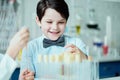 Happy schoolboy with flasks in chemical lab Royalty Free Stock Photo