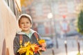 Happy schoolboy standing outside with maple bunch Royalty Free Stock Photo