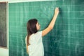 Happy schoolchild writing on blackboard Royalty Free Stock Photo