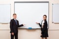 Happy schoolchild writing on blackboard. Royalty Free Stock Photo