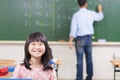 Happy schoolchildren in class with teacher