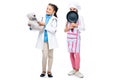 happy schoolchildren in costumes of doctor and chef holding teddy bear and frying pan