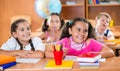 Happy schoolchildren during lesson in classroom Royalty Free Stock Photo