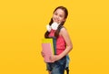 Happy schoolgirl with books and headphones