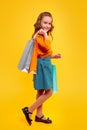 Happy schoolgirl in casual outfit enjoying shopping