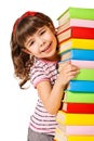 Happy schoolgirl holding pile of books Royalty Free Stock Photo