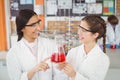 Happy schoolgirls doing a chemical experiment in laboratory