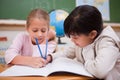 Happy schoolgirls doing classwork