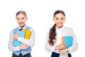 Happy schoolgirls in formal wear with books looking at camera Isolated On White.