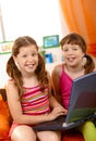 Happy schoolgirls with laptop Royalty Free Stock Photo