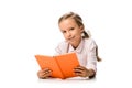 happy schoolkid holding orange book and smiling on white.