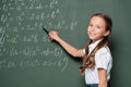 happy schoolkid pointing with pen at