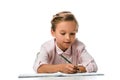 happy schoolkid smiling and holding pencil near notebook isolated on white.