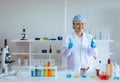 Happy scientist asian woman studying medical chemicals and showing thumb up in laboratory