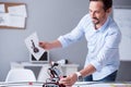 Happy scientist holding a prototype of his invention Royalty Free Stock Photo