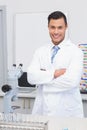 Happy scientist smiling at camera with arms crossed