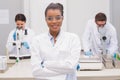 Happy scientist smiling at camera with protective glasses