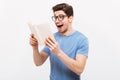 Happy screaming nerd in eyeglasses and t-shirt reading book Royalty Free Stock Photo