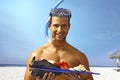 Happy scuba diver holding seashells