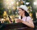 Happy, search or woman with phone on park bench in morning for social media, networking or reading comic blog. Smile