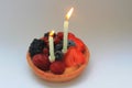 A happy birthday wishes for the second anniversary celebrated with a cake with fruits Royalty Free Stock Photo