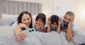 Happy, selfie and children with parents in bed relaxing and bonding together at family home. Smile, fun and young mother Royalty Free Stock Photo