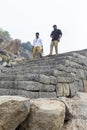 Happy Senior Adult man Tourist clumbing up the steps at Gingee, Tamil Nadu, India