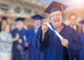 Happy Senior Adult Woman In Cap and Gown At Outdoor Graduation C Royalty Free Stock Photo