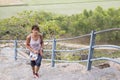 Happy Senior Adult woman Tourist clumbing up the steps at Gingee, Tamil Nadu, India