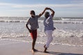 Happy senior african american couple dancing together on the beach Royalty Free Stock Photo