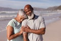 Happy senior african american couple embracing each other on the beach Royalty Free Stock Photo