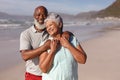 Happy senior african american couple embracing each other on the beach Royalty Free Stock Photo