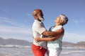 Happy senior african american couple hugging each other on the beach Royalty Free Stock Photo