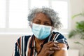 Happy senior african american woman wearing face mask with plaster on arm after vaccination Royalty Free Stock Photo