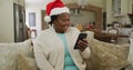 Happy senior african american woman wearing santa hat at chrsitmas time