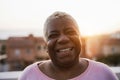 Happy senior african woman smiling on camera outdoor in the city - Focus on face Royalty Free Stock Photo