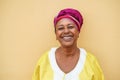 Happy senior african woman wearing traditional dress looking at camera - Focus on face Royalty Free Stock Photo