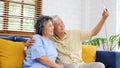 Happy senior asian couple taking selfie at home living room, active senior people in happy moment, casual retirement people with Royalty Free Stock Photo