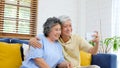 Happy senior asian couple taking selfie at home living room, active senior people in happy moment, casual retirement people with Royalty Free Stock Photo