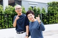 Happy senior Asian couple walking and pointing in outdoor park and house. Royalty Free Stock Photo