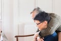 Happy senior asian father and adult son using computer laptop talking on video call in living room Royalty Free Stock Photo