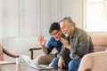 Happy senior asian father and adult son using laptop talking on video call in living room Royalty Free Stock Photo