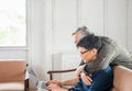 Happy senior asian father and adult son using laptop talking on video call in living room Royalty Free Stock Photo