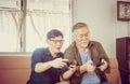 Happy Senior asian father and middle aged son playing video game together in living room, Happiness Asian family concepts Royalty Free Stock Photo