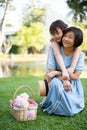 Happy senior Asian grandmother and her cute little girl granddaughter are hugging in the green park Royalty Free Stock Photo