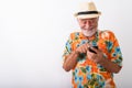 Happy senior bearded tourist man smiling and giggling while using phone Royalty Free Stock Photo